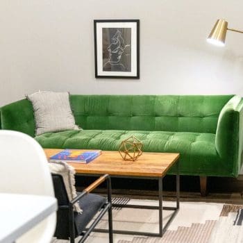 A green sofa in a living room