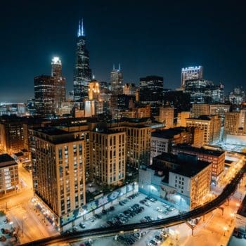 An overhead view of buildings and parking lights at nighttime in Chicago