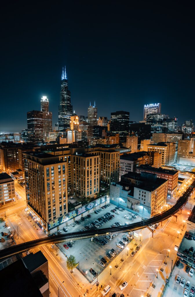 An overhead view of buildings and parking lights at nighttime in Chicago