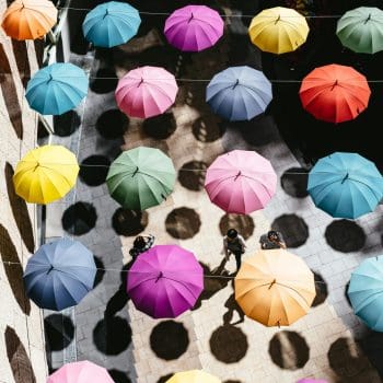 An overhead shot of umbrellas of various colors