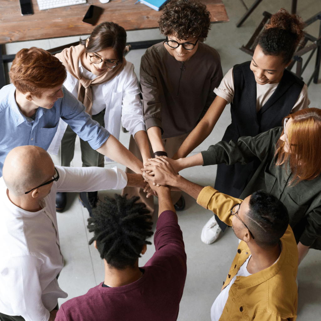 Coworkers putting their hands together in a circle